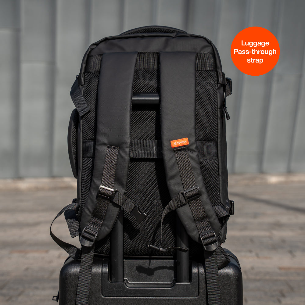 Back view of black travel backpack with luggage pass-through strap and padded shoulder straps