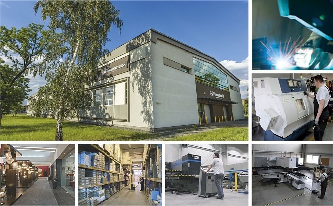 Nowoczesna, jednokondygnacyjna hala produkcyjna z białą fasadą otoczona zielenią i brzozą